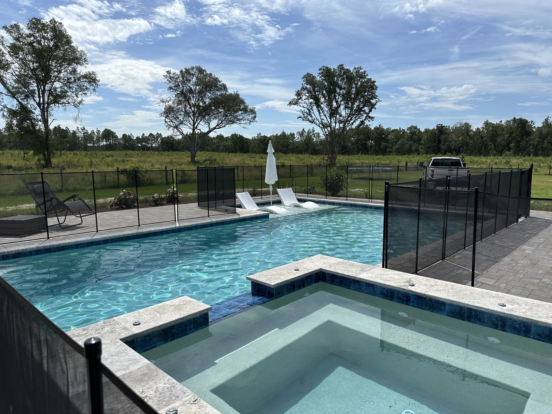 Custom pool and raised spa with safety fencing